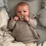 Baby girl wearing oatmeal roll neck vest