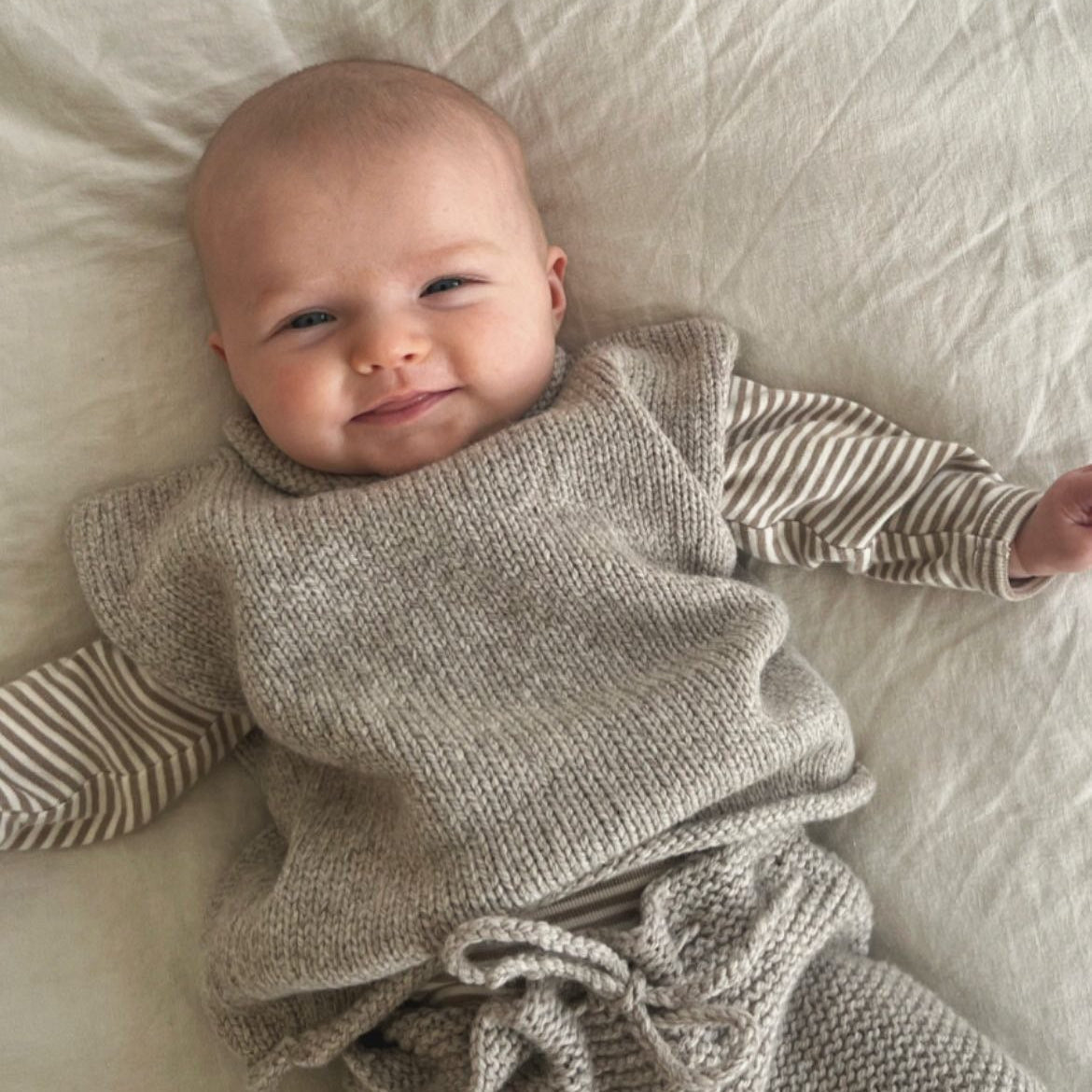 Baby in cot wearing Oatmeal Roll Neck Vest