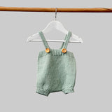 Baby romper in mint on hanger
