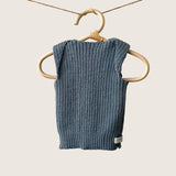 Dusky blue ribbed baby singlet hanging on a wooden hanger against a plain background