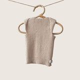 Sand ribbed baby singlet hanging on a wooden hanger against a plain background