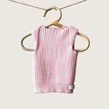 Blossom pink baby singlet hanging on a wooden hanger against a gray background