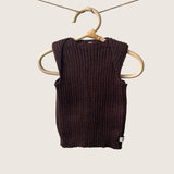 Brown ribbed baby singlet on a wooden hanger against a gray background