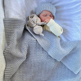 Baby sleeping in misty blue bassinet blanket