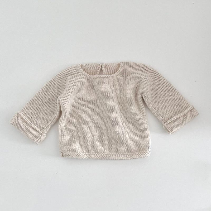 Natural knitted baby slouchy sweater on a white background