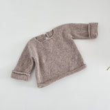 Oatmeal knitted baby slouchy sweater on a white background