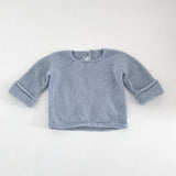 Powder blue knitted baby slouchy sweater on a white background