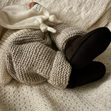 Baby wearing chunky knit pants and lambskin chocolate booties