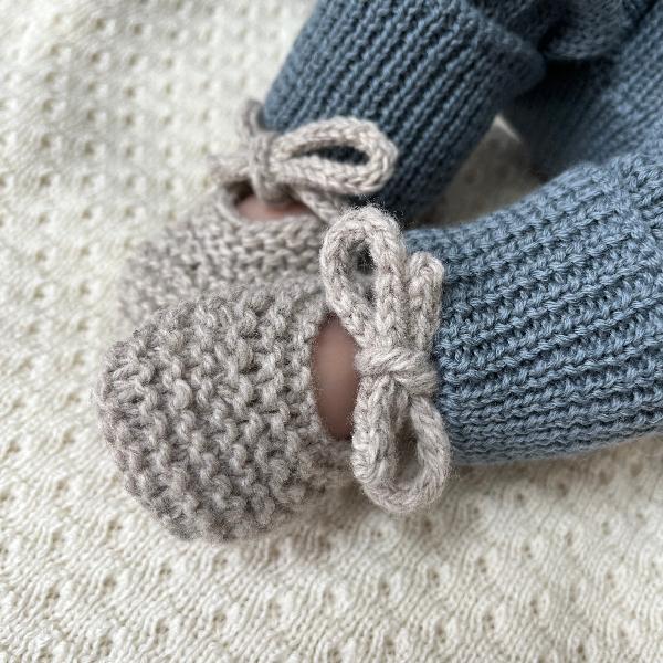 Baby wearing little swan slippers