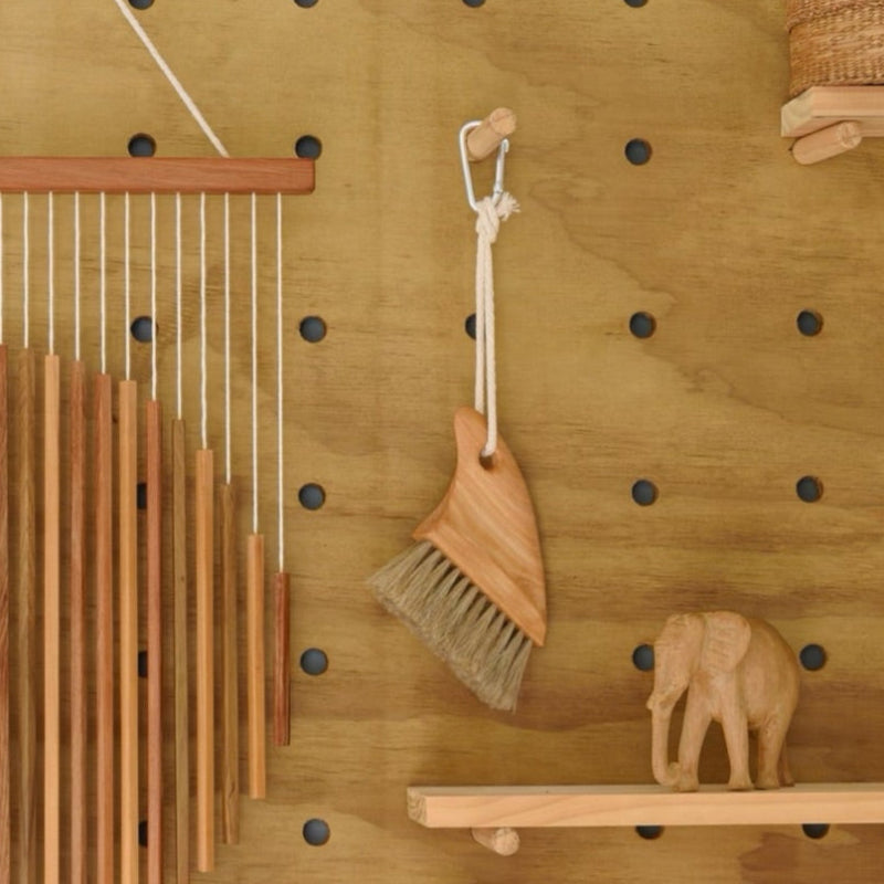 Beach brush hanging on peg board