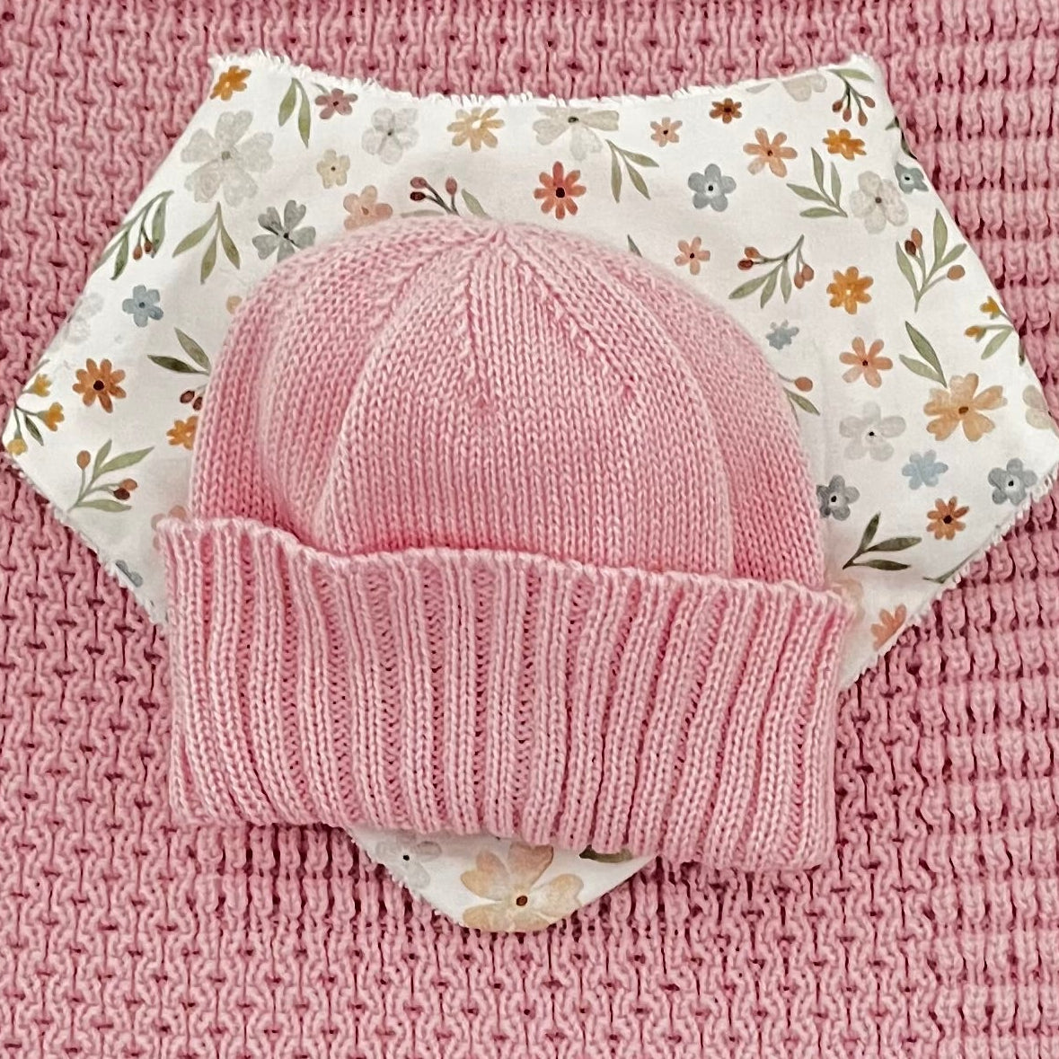 close up of blossom pink pram blanket newborn beanie dribble bib