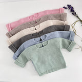 flat lay of baby slouchy sweaters