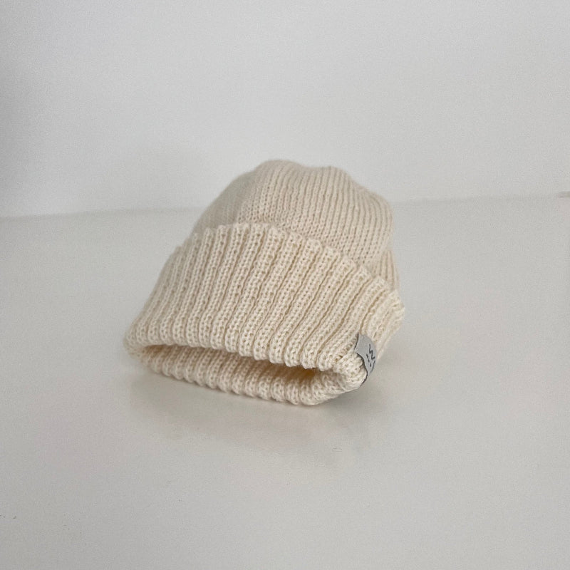 knitted ivory newborn beanie on white shelf