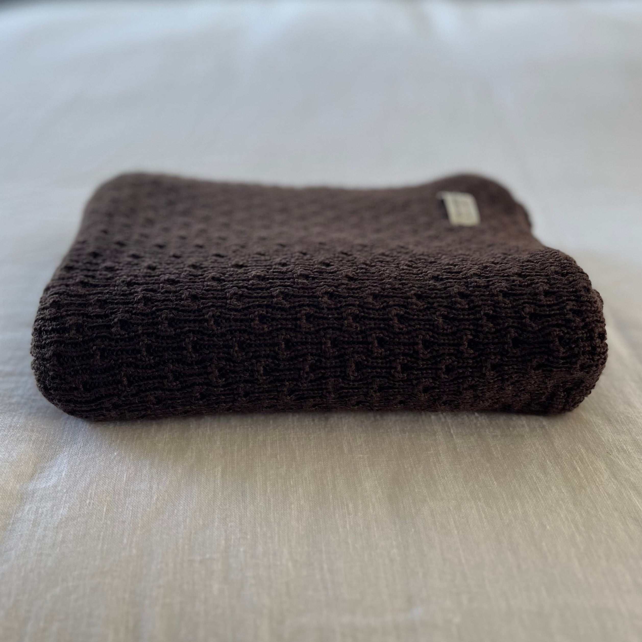 brown textured baby wrap on a light-colored surface