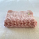 Blossom pink baby wrap on a light-colored surface