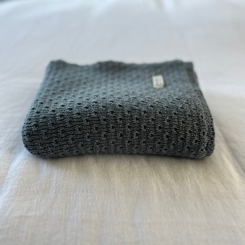 Dusky blue baby wrap on a light-colored surface