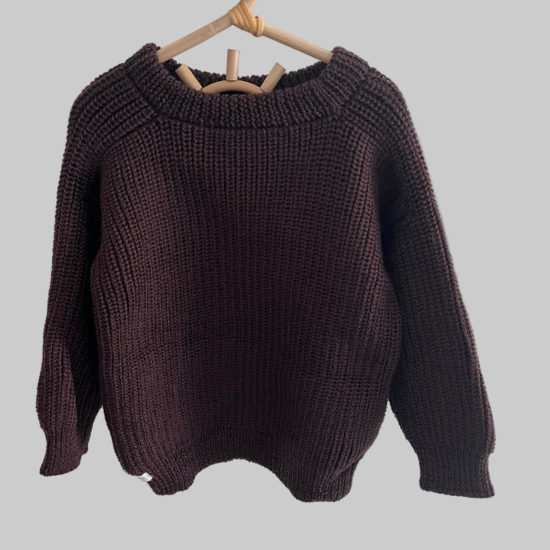 Brown knitted river jumper on a hanger against a white background