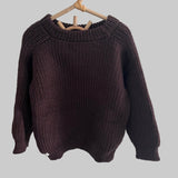Brown knitted river jumper on a hanger against a white background