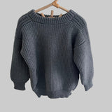 Dusky blue knitted river jumper on a hanger against a white background