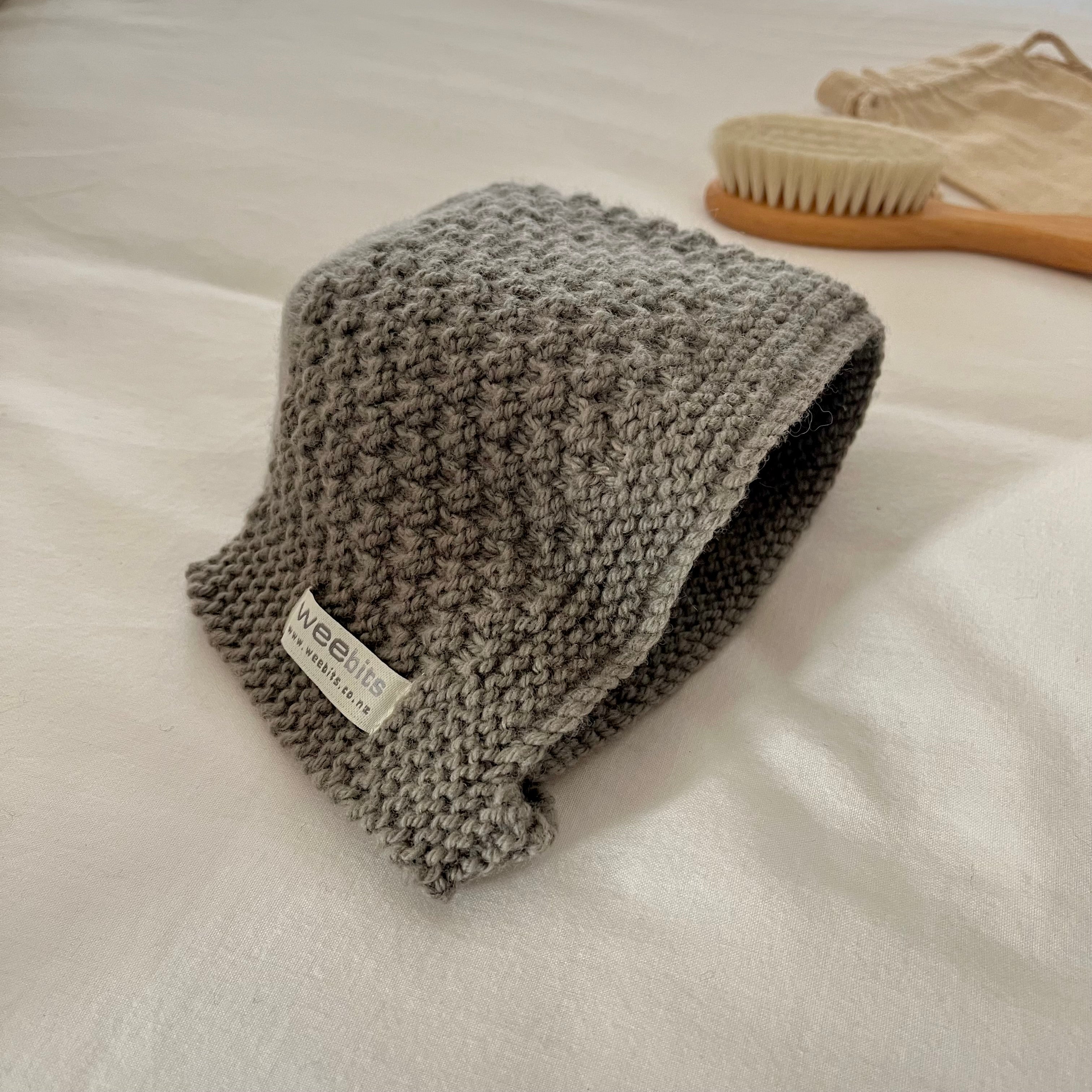 mushroom knitted bonnet with a label on a white surface