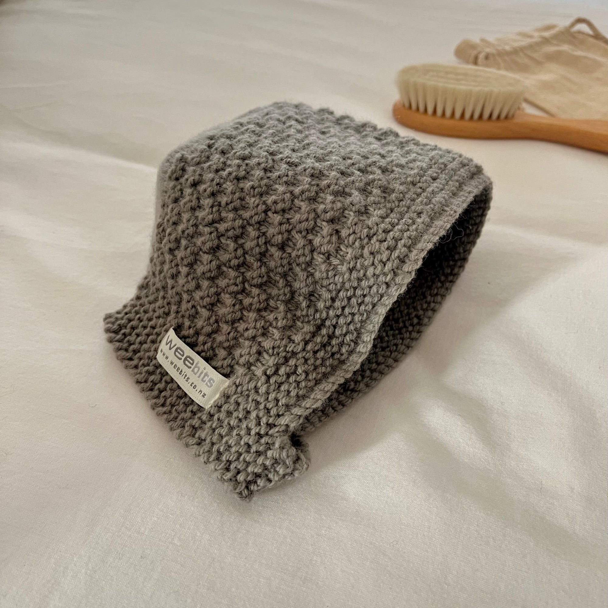 mushroom knitted bonnet with a label on a white surface