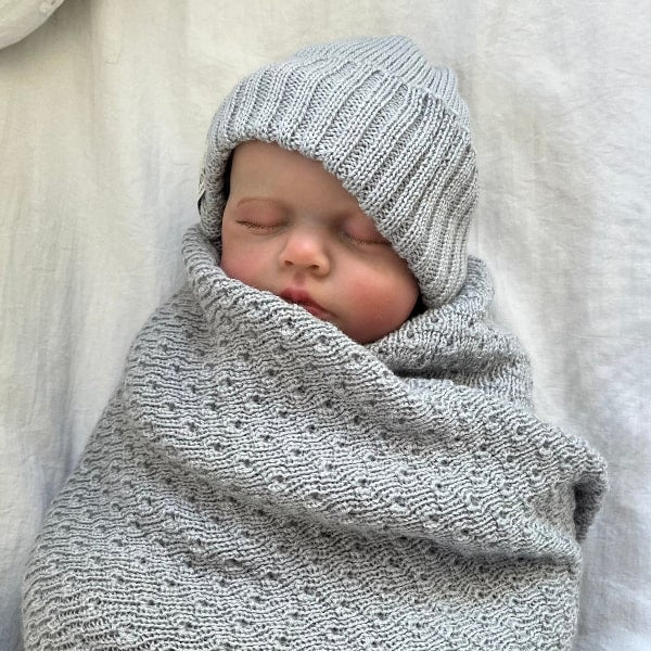 Newborn swaddled in misty blue merino wrap and beanie