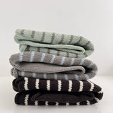 Three-striped-hoodies-side-view-on-white-bench
