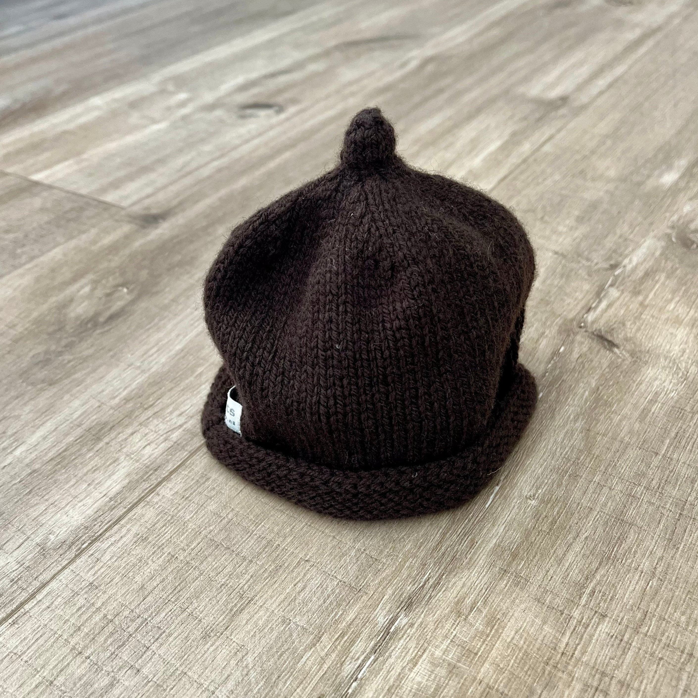 Baby-pixie-point-beanie-chocolate-colour-on-wooden-surface