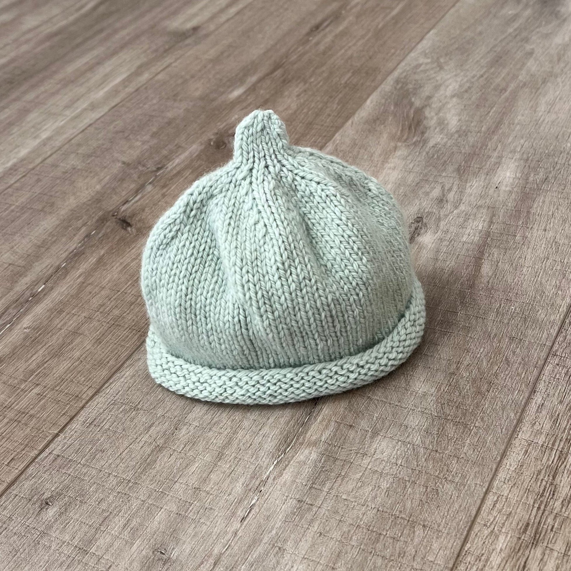 Baby-pixie-point-beanie-mint-colour-on-wooden-surface