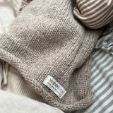 Side view of oatmeal roll neck vest