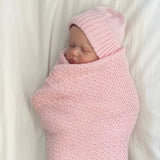 Sleeping baby in blossom pink merino baby wrap and beanie