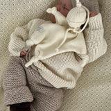 Sleeping baby wearing natural river jumper