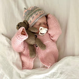 sleeping baby wearing pink millie cardigan