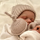 sleeping baby with oatmeal beanie and snow baby comforter