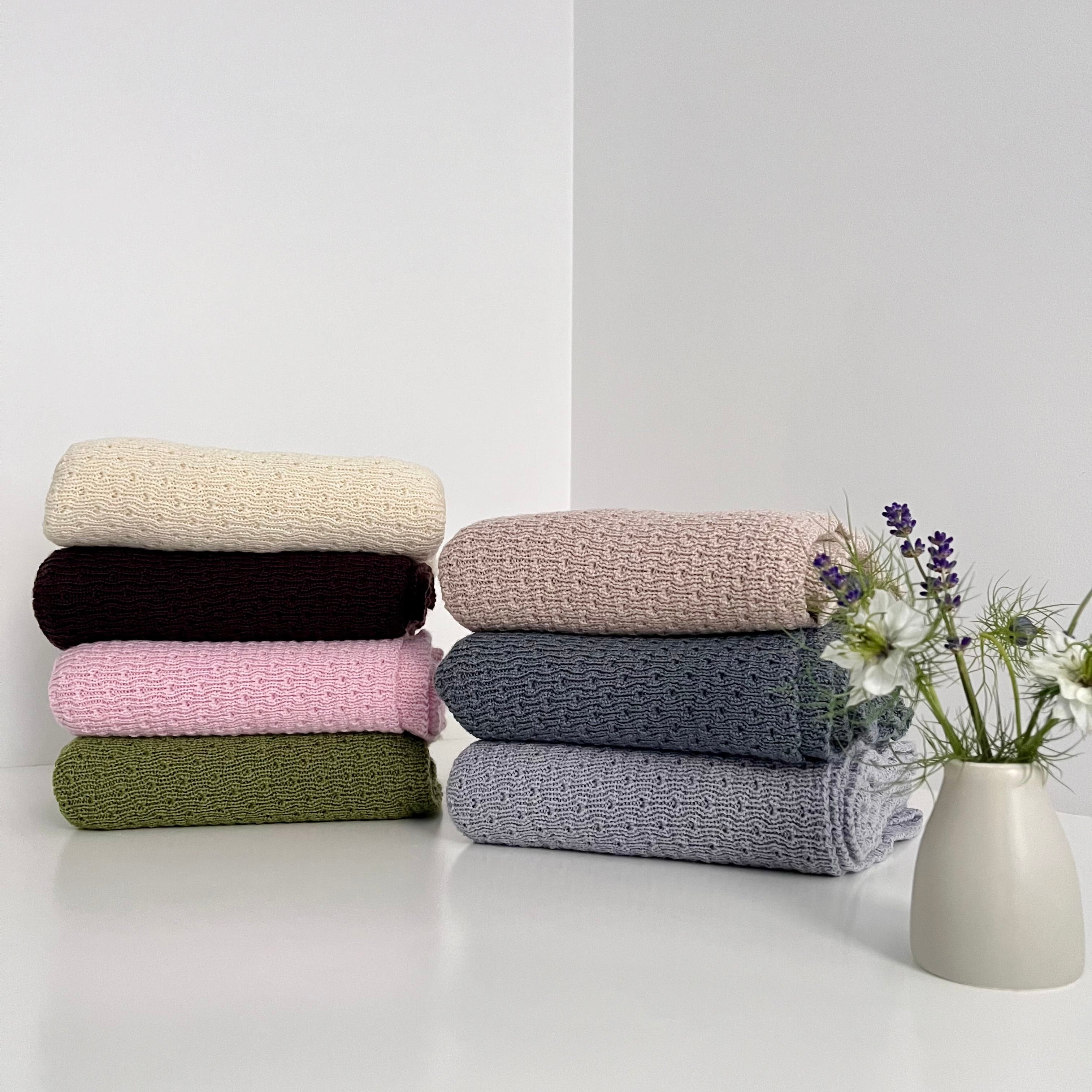 Stack of coloured merino baby wraps