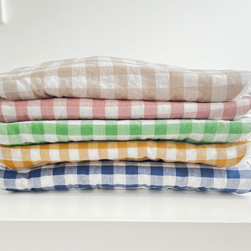 Stack of five gingham bibs