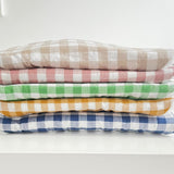 Stack of five gingham bibs