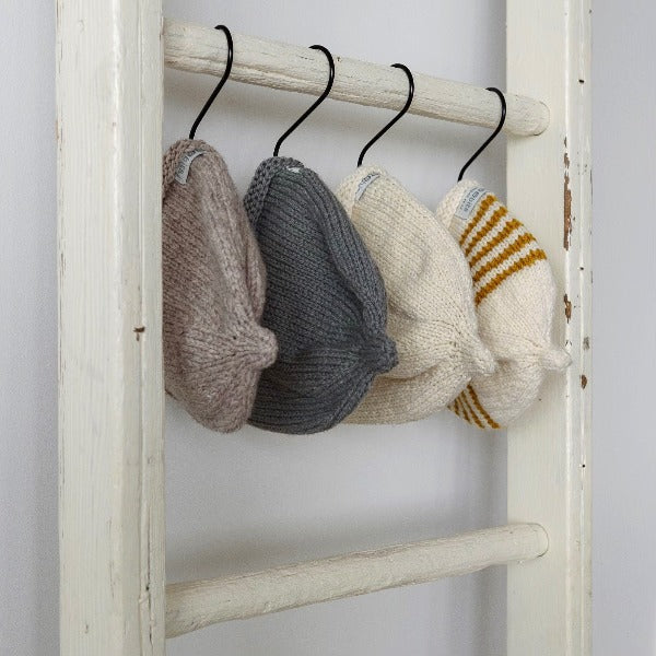 Baby beanie hanging from a ladder
