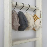 Baby beanie hanging from a ladder