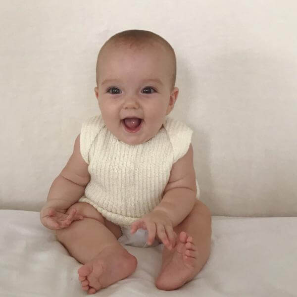 Baby wearing Ivory baby singlet
