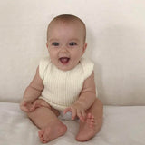Baby wearing Ivory baby singlet