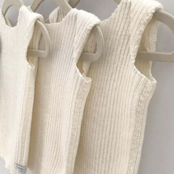 fine merino singlet vests on hangers