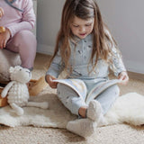 Girl in natural toddler slippers