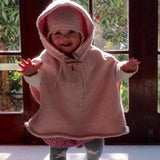 Girl in pink hooded cape
