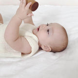 Baby wearing ivory singlet