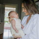 Mother with child wearing natural baby dungarees
