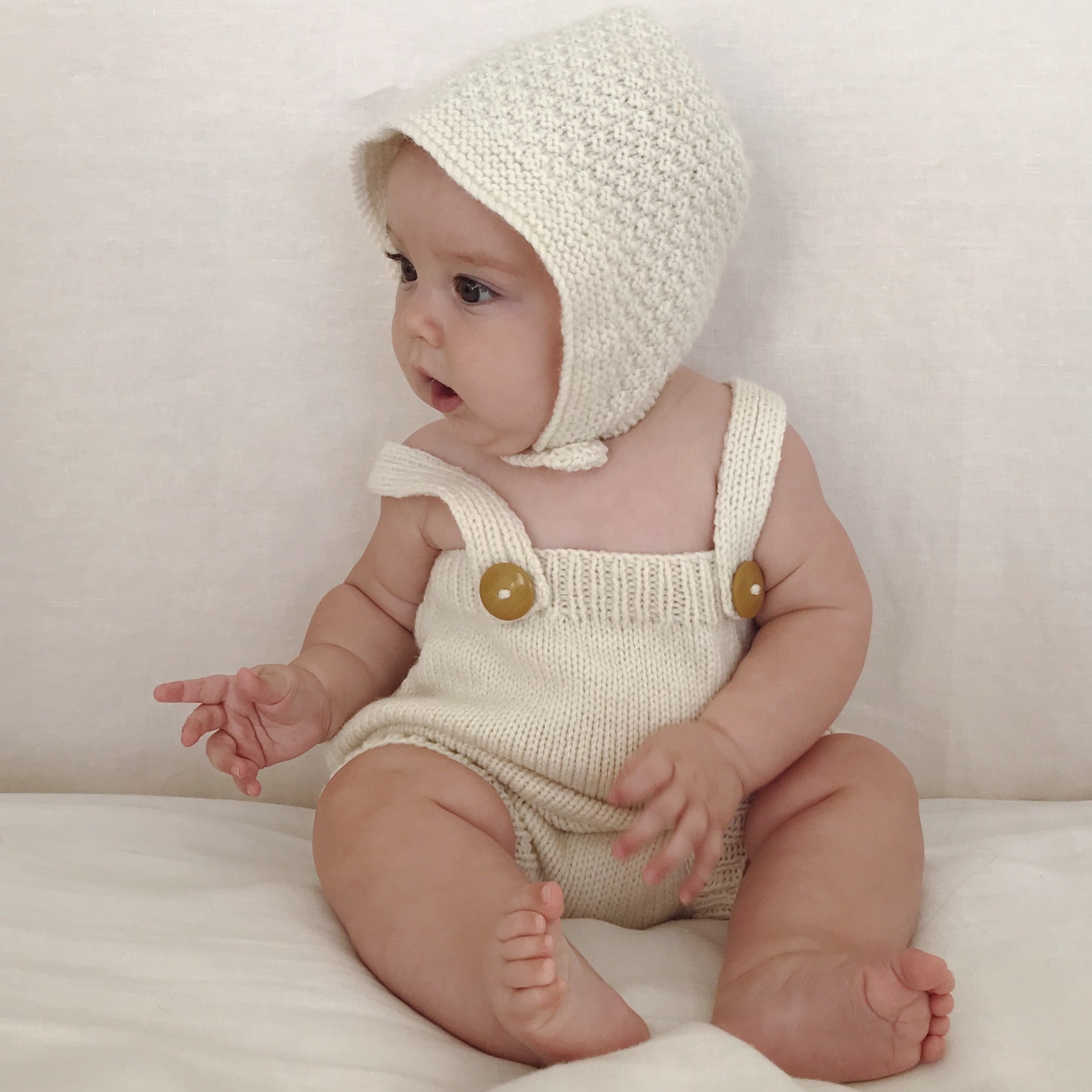 Baby wearing natural newborn bonnet