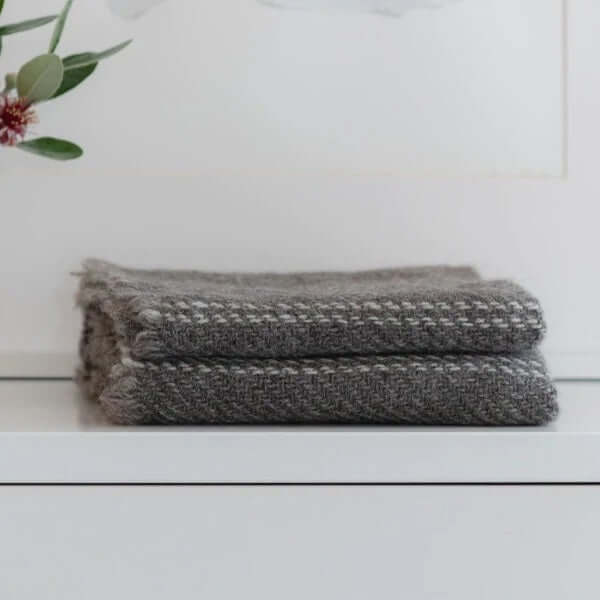 Solid grey stansborough cot blankets on shelf