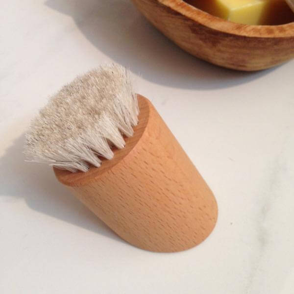 wooden facial brush on bench