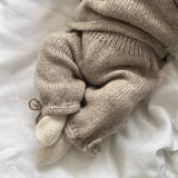 Oatmeal knitted baby pants with ankle tie